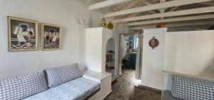 a living room with a couch and a hallway at Peloponnese Hideout - Traditional Stone House in Akrata +84 photos