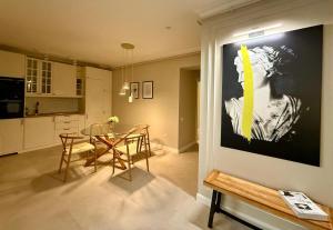 a kitchen and dining room with a table with chairs at Riviera Apartment in Buzău