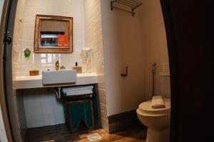 a bathroom with a sink and a toilet at Pousada Do Largo in Tiradentes