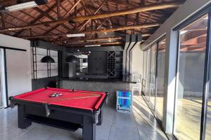 a pool table in the middle of a room at Casa de 3 quartos com piscina in Laranjeiras do Sul