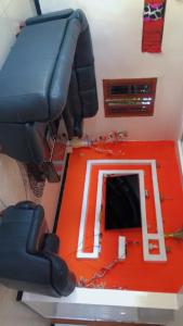 a living room with a couch and a red floor at Tango in Ndangane