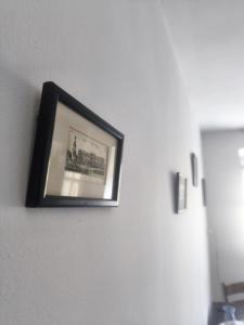 a picture hanging on a wall in a room at Neo Retro in Jelenia Góra
