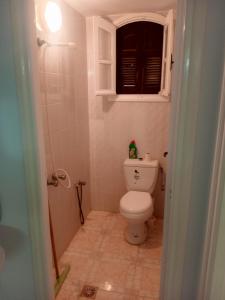 a bathroom with a toilet and a window at Studio AMINE in Mahdia