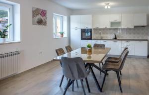 a kitchen and dining room with a table and chairs at Awesome Home In Imotski in Imotski