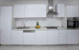 a white kitchen with white cabinets and a sink at Awesome Home In Imotski in Imotski