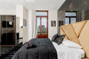 a bedroom with a large bed and a large window at Nova Suite in Catania
