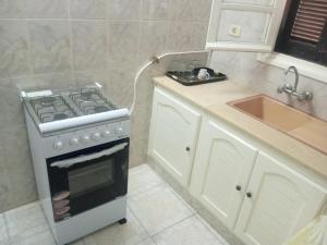 a kitchen with a stove and a sink at Studio AMINE in Mahdia +1 photo