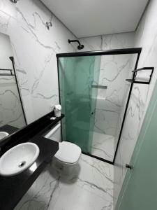 a bathroom with a shower and a toilet and a sink at Residencial Pantanal Vila Mariana in Sao Paulo