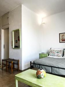 a bedroom with a bed and a table and a mirror at Αριάδνη στούντιο με θέα in Anavyssos +35 photos
