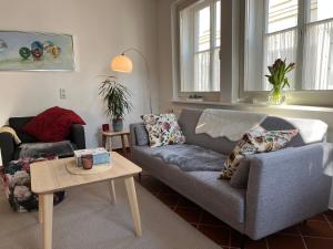 a living room with a couch and a table at Ferienwohnung am Kirchplatz 25561 in Weener +5 photos