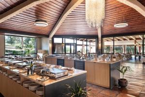 a restaurant with a buffet line in a building at Roccamare Resort - Ville e Appartamenti in Castiglione della Pescaia