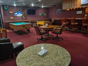 a conference room with a pool table and chairs at The Lodge at Russell - Russell Inn in Russell