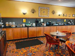 a restaurant with a table and chairs and a kitchen at The Lodge at Russell - Russell Inn in Russell