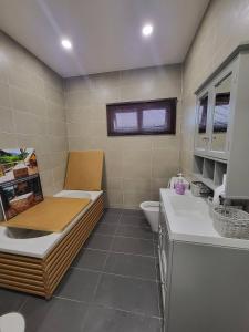 a bathroom with a toilet and a sink at Luxury Tropical Bungalow in Damansara Golden Core in Kuala Lumpur