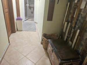 a hallway with aoyer with a toilet and a trunk at Стая за двама в град Бургас in Burgas City +1 photo