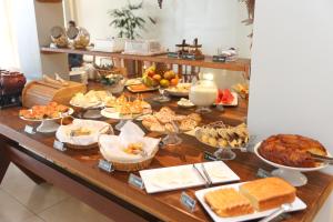 a buffet with many different types of food on a table at Alfa Hotel Teresina in Teresina