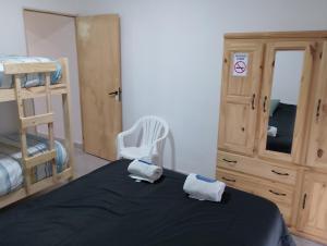 a bedroom with a bed with two towels on it at Departamento NAMASTE II in Carhué