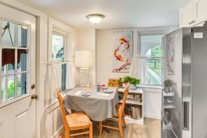 a dining room with a table and chairs and a refrigerator at Private Heated Pool Family Cottage in Plymouth! in Plymouth +19 photos