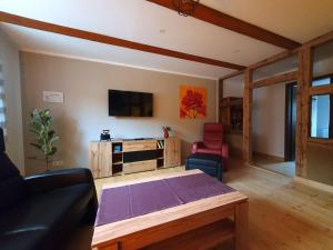 a living room with a couch and a table at Kleine Bergstraße 2 - Haus 1 in Tanne