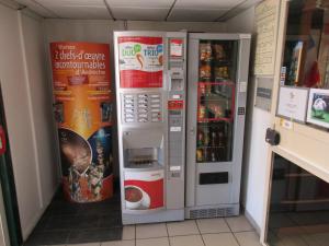 a large vending machine in a store with its door open at Premiere Classe Avignon Le Pontet in Le Pontet