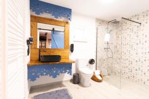 a bathroom with a toilet and a shower at Pension La Roata in Gura Humorului +133 photos