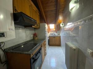 a small kitchen with a sink and a stove at Apartamento céntrico en Benasque in Benasque