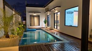 a swimming pool in the middle of a house at Vila Kelapa Gading Banjarbaru Syariah in Martapura