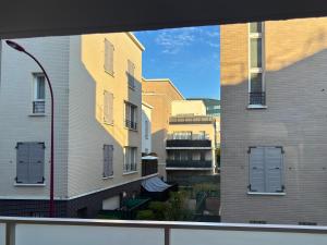 a view of some buildings from a window at Bezons Golden - 3 chambres - 3min du Tramway #SirDest in Bezons