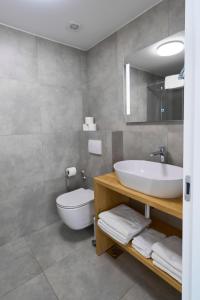 a bathroom with a sink and a toilet at Apartments Lukas 7 in Zadar