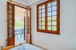 a room with a door and a window and a table at Vergici Apartment 2 in Kómi +3 photos