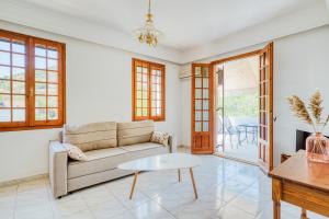 a living room with a couch and a table at Vergici Apartment 2 in Kómi