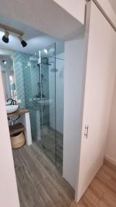 a bathroom with a glass shower and a sink at Casa Lagoa in Lagoa +12 photos