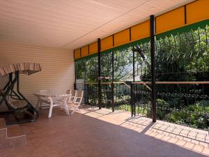 a patio with a table and chairs and a fence at Дом у моря in Odesa