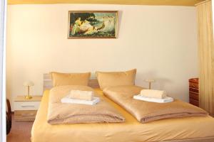 a bedroom with a bed with two pillows on it at Haus Zeitlos Brunnenblick in Lübbenau +9 photos