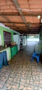 an empty room with a table and a blue chair at Camping Refugio SacodoCeu2026 in Saco do Ceu