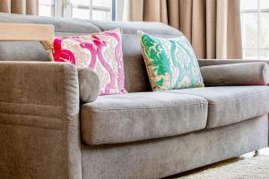 a couch with two pillows on it in a living room at Alte Fischfabrik Lauterbach "August 24" in Lauterbach
