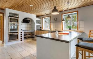 a large kitchen with a large island in a room at 8 Bedroom Nice Home In Rømø in Bolilmark