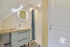 a bathroom with a sink and a mirror at Les agapanthes in Ploemeur +26 photos