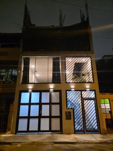 a house with large windows on the side of it at sabina nuevo aeropuerto x12 in Lima +8 photos