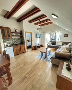 a living room with a couch and a table at Etno Garden Apartments in Plitvička Jezera +75 photos