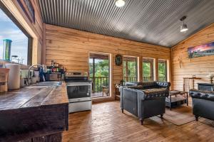 a kitchen with wooden walls and a wooden floor at Ohio Starlight Glamping Cabins - A Peaceful Woodland Retreat 