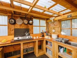 a kitchen with wooden walls and a counter with a stove at 1 Bed in Anglesey 73316 in Gaerwen