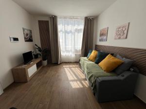 a living room with a couch and a television at Rubiera Sunny Apartments in Rubiera