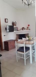 a kitchen with a white table and a table and chairs at Stella Marina in Tertenìa +16 photos
