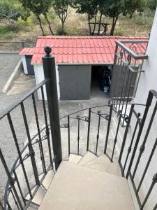 a stairway with a building with a red roof at Riaci Bay in Tropea