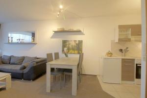 een keuken en woonkamer met een tafel en een bank bij Apartment 411 in Hohegeiß