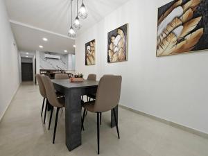a dining room with a table and chairs at Blossom in Marsaskala