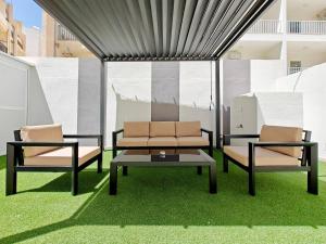 two chairs and a coffee table on some grass at Blossom in Marsaskala
