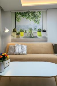 a living room with a couch and a window with potted plants at Gate303 in Seoul