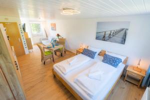 a bedroom with a bed and a living room at Wohnung Mien Kajuet ID 455 in Oldenswort